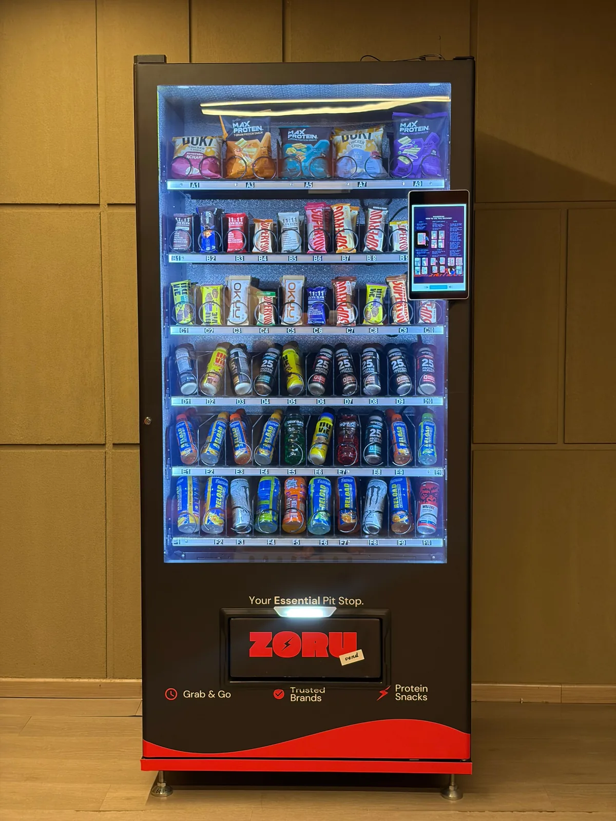 The full height of a stocked Zoruvend machine, with the payment tablet mounted at eye level on the right